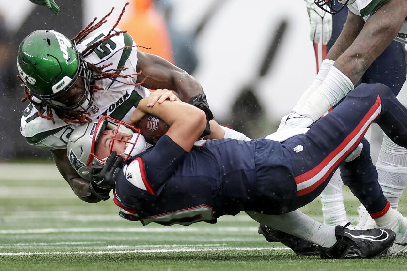 New England Patriots quarterback Mac Jones (10) is sacked by New York Jets linebacker C.J. Mosley (57) during the fourth quarter of an NFL football game, Sunday, Sept. 24, 2023, in East Rutherford, N.J. (AP Photo/Adam Hunger)