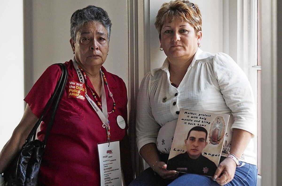 Maria Herrera, left, and Araceli Magdalena Rodriguez are in Los Angeles on the Caravan of Peace. Herrera's four sons have all disappeared. Rodriguez's son, a federal police officer, was executed by organized crime figures.