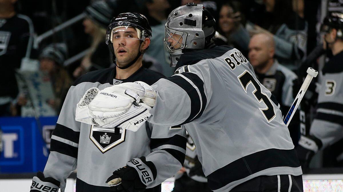 Kings goalie Ben Bishop, right, talks to Alec Martinez after the defenseman's goal against the Vancouver Canucks during the third period on March 4.