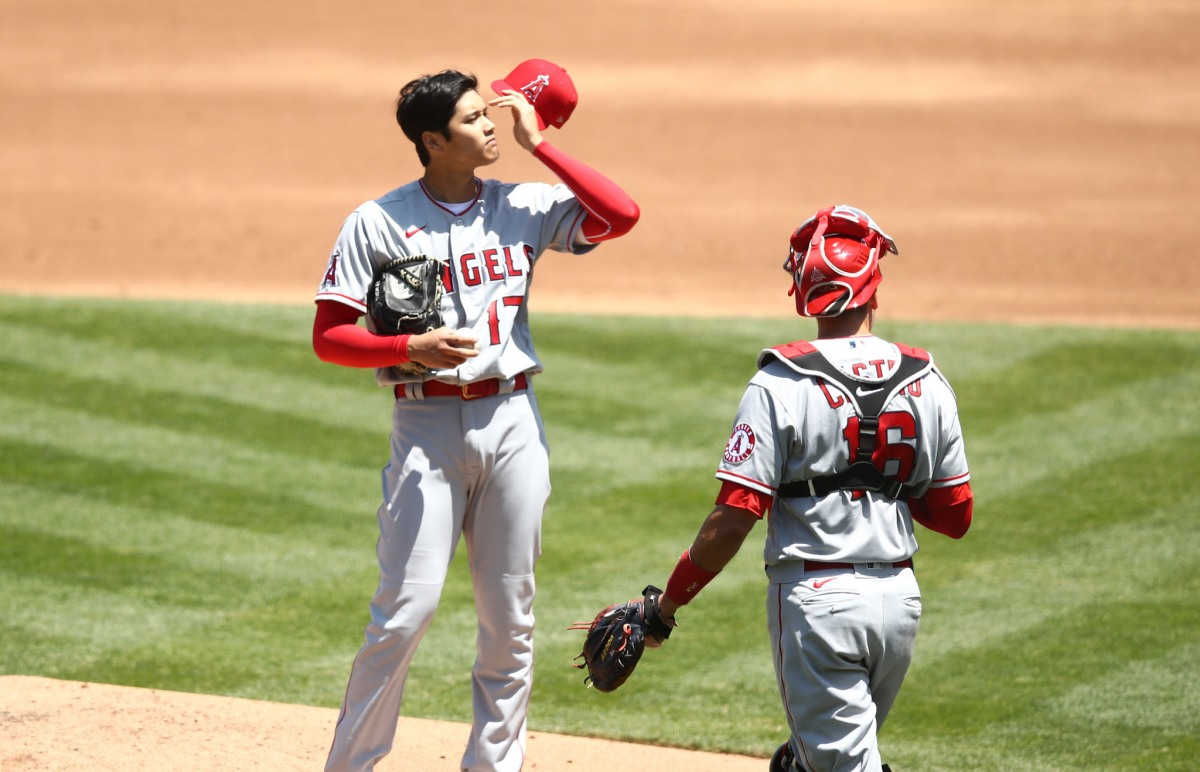 Angels catcher Jason Castro comes out to talk to Shohei Ohtani during the first inning.