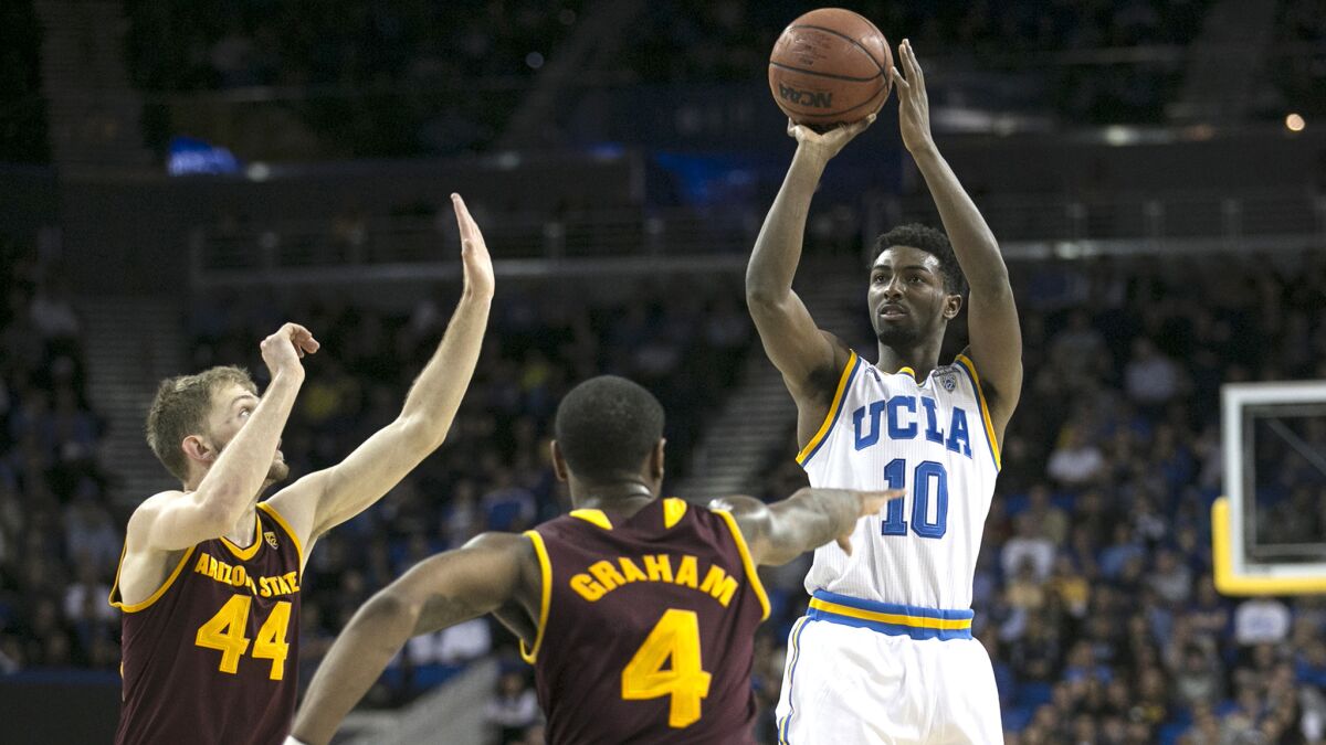 UCLA guard Isaac Hamilton shoots a three-pointer over Arizona State defenders Kodi Justice (44) and Torian Graham during the first half Thursday night at Pauley Pavilion.