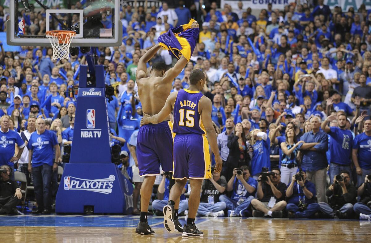 Lakers center Andrew Bynum takes off his jersey after being ejected from the game