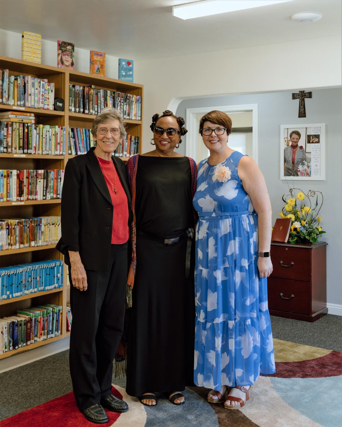 Sister Paulette Deters, left, with librarian Victoria Burnett and current Principal Kelly Botto at the school's new library.