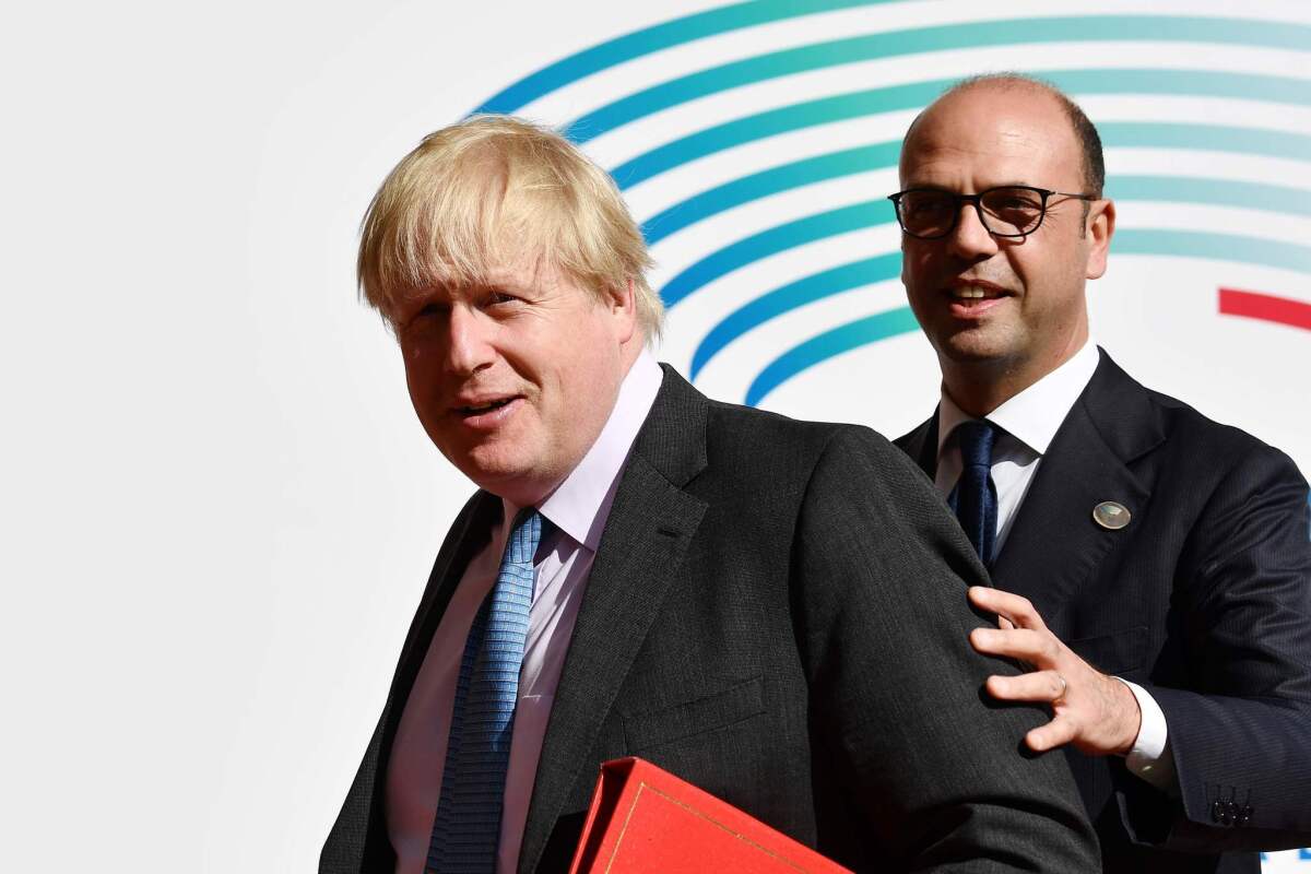 Italian Foreign Minister Angelino Alfano, right, welcomes British Foreign Secretary Boris Johnson as he arrives for a meeting of Group of 7 foreign ministers in Lucca, Italy, on April 10, 2017.