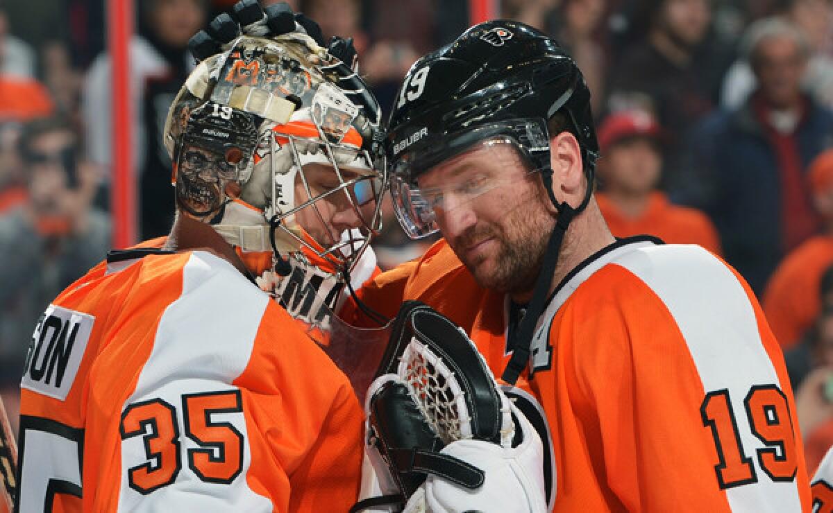 Philadelphia Flyers goalie Steve Mason, left, is congratulated by teammate Scott Hartnell following a 4-1 win over the St. Louis Blues on Saturday. After a disappointing start nearly derailed their season, a more confident Flyers team is working toward the ultimate goal of winning the franchise's first Stanley Cup in nearly four decades.