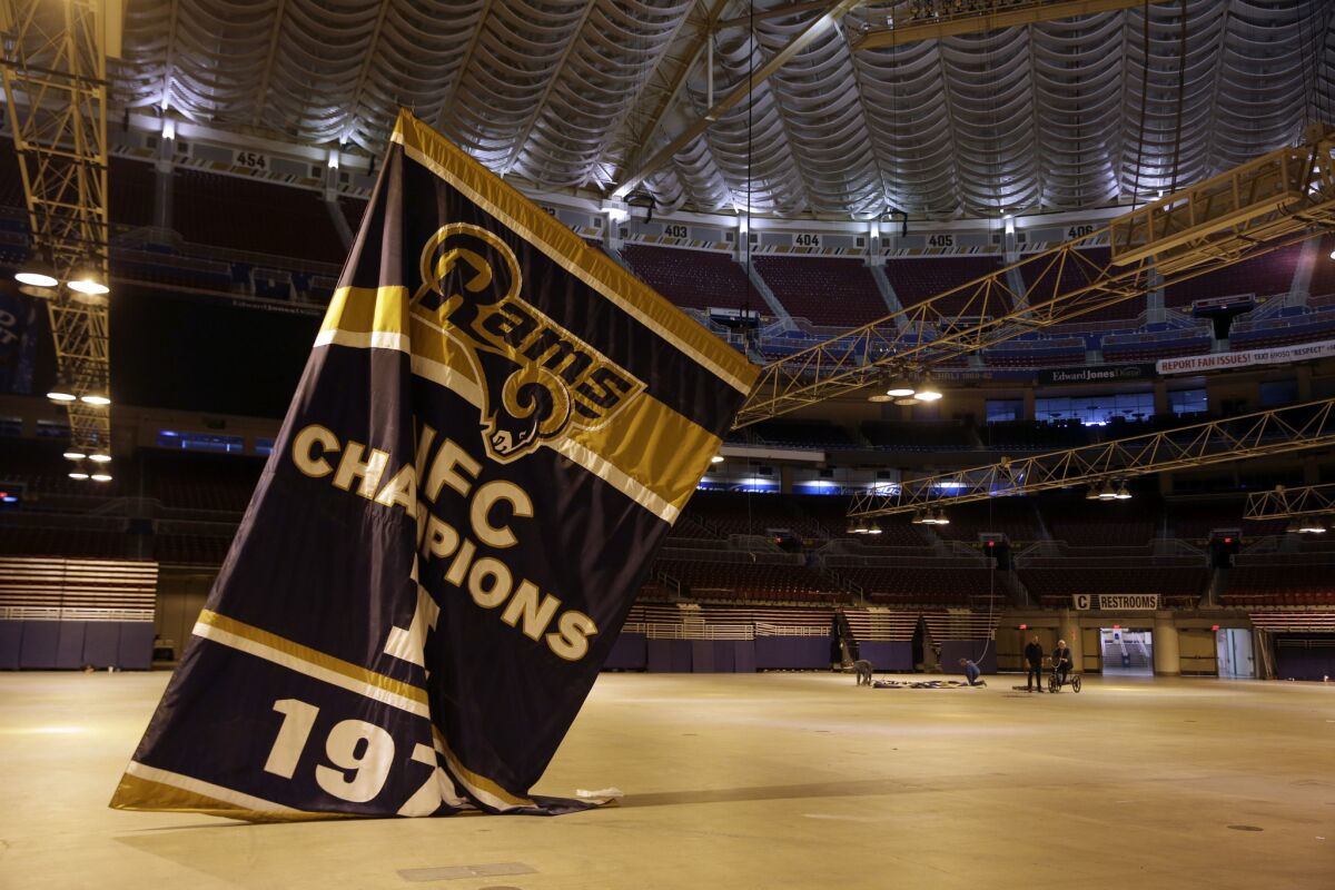 Championship banners are removed from the Edward Jones Dome, former home of the St. Louis Rams, on Jan. 14. The start of a new NFL season is bringing no buzz of excitement in St. Louis, left without a team for the second time in three decades.