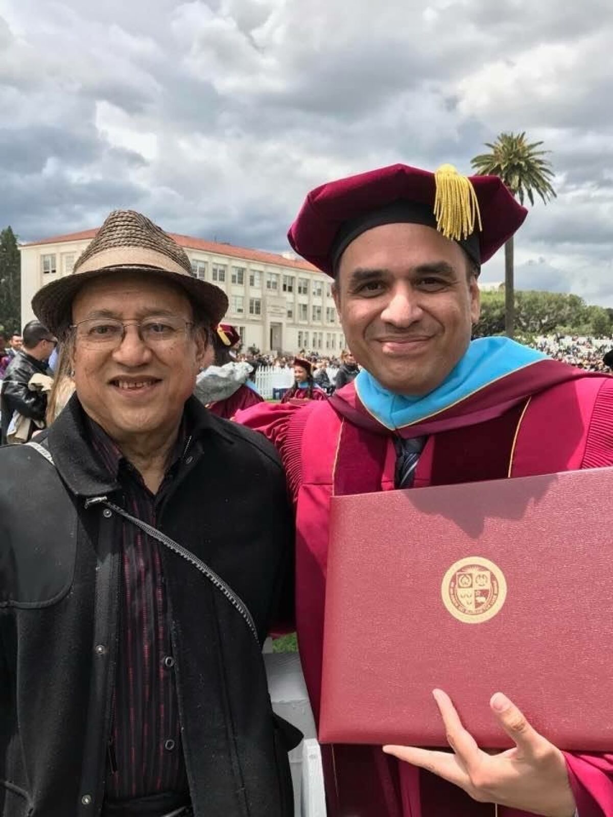 Writer and therapist Luis S. Garcia with his father in 2017 at his Loyola graduation.