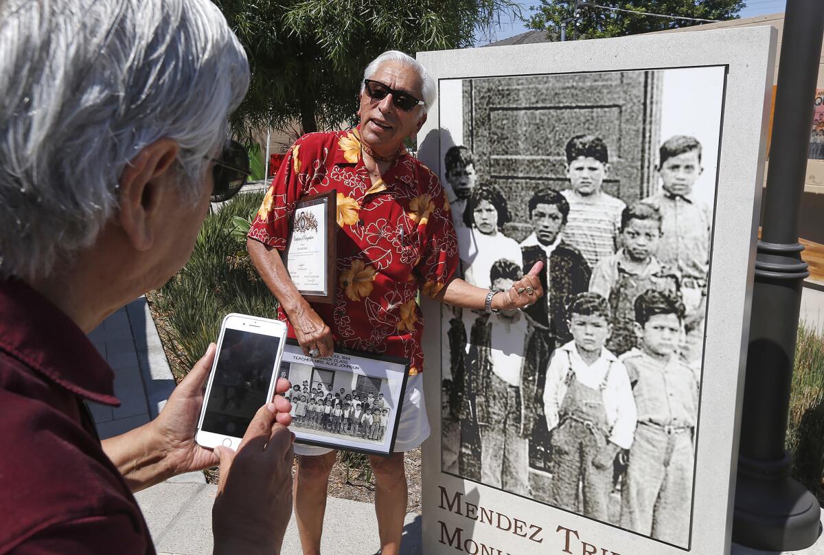 Frank Mendoza, points to himself in a class picture from 1944 on Tuesday.