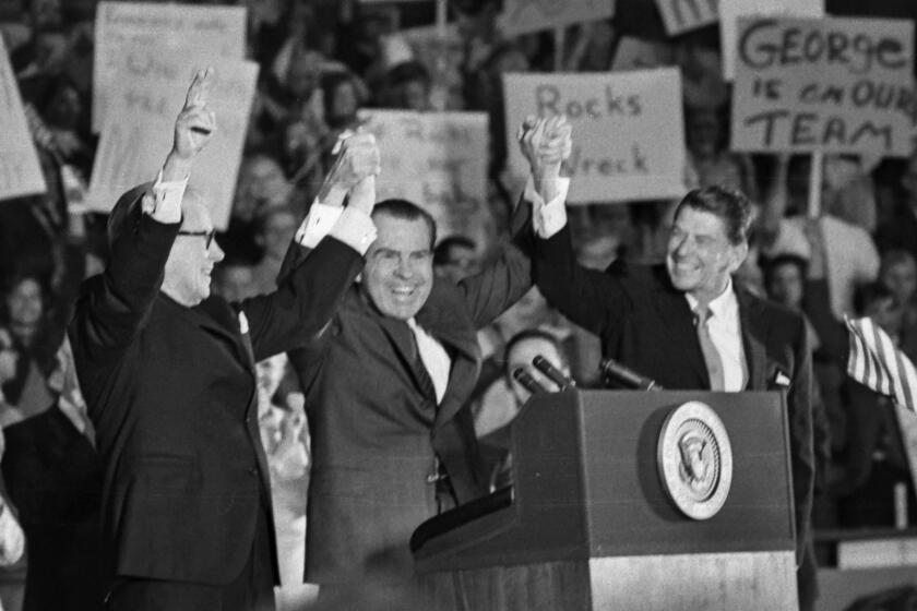 Oct. 30, 1970: Richard Nixon clasping hands with Ronald Reagan and Senator George Murphy at Republican rally in Anaheim.