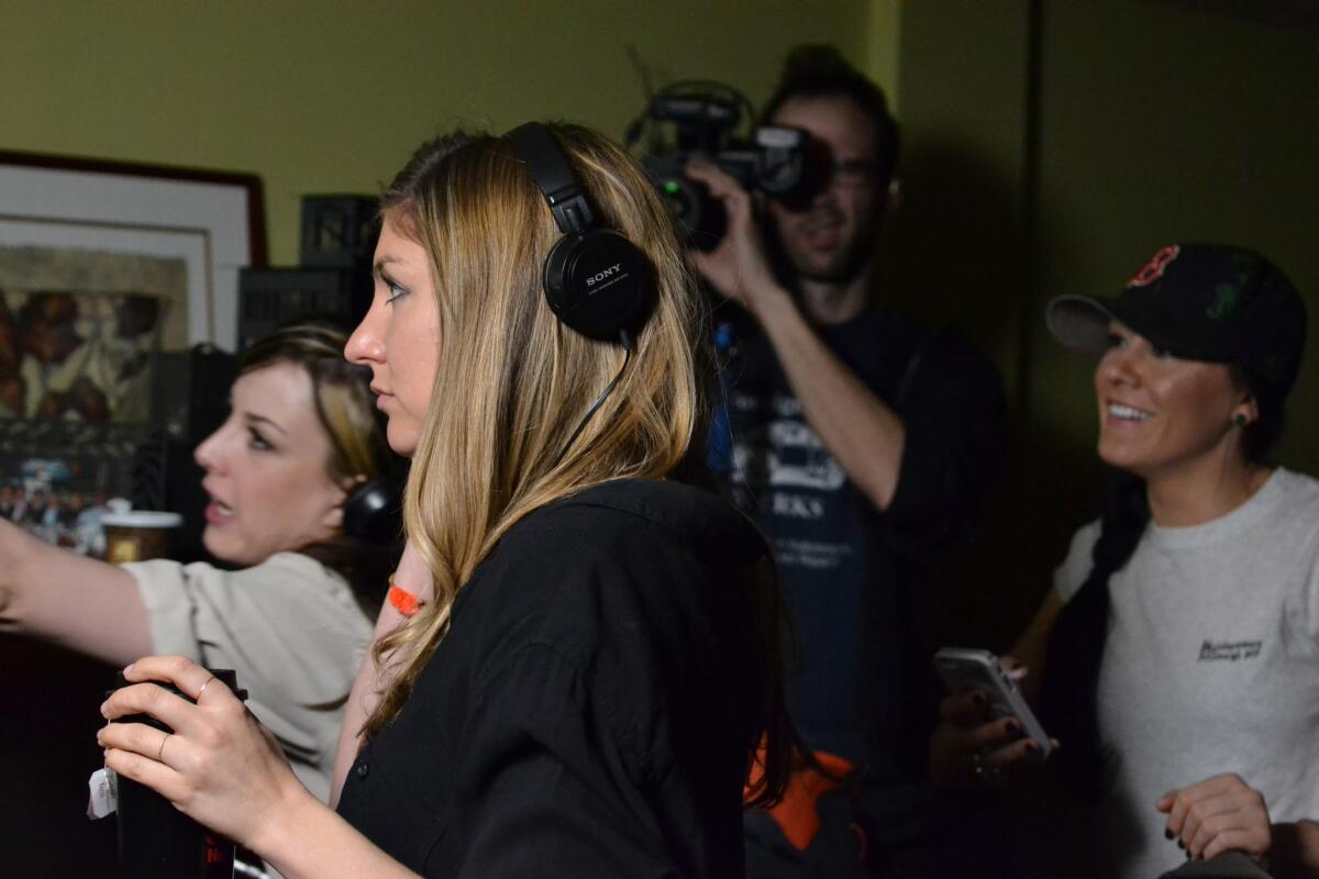 Director Anna Martemucci, with headphones, works on the set of her film, "Hollidaysburg," in Carnegie, Pa.