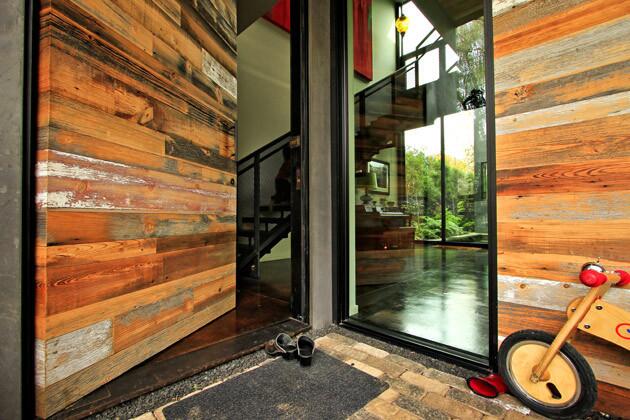 Reclaimed wood walls lend texture and warmth at the entry.
