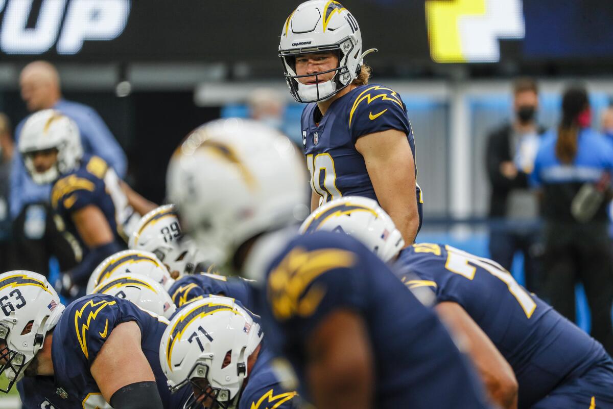  Chargers quarterback Justin Herbert (10) looks over the Patriots' defense before the snap.