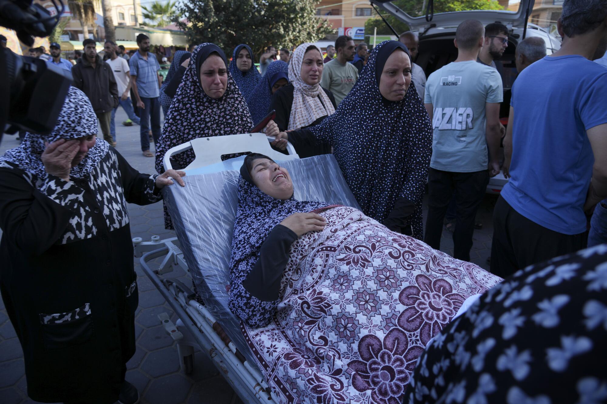 Wounded woman being brought to a hospital in Gaza