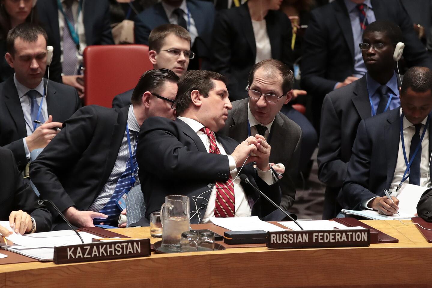 Russian Deputy Permanent Representative to the United Nations Vladimir Safronkov confers with aides during a meeting of the United Nations Security Council concerning the situation in Syria, at U.N. headquarters on April 7 in New York City.