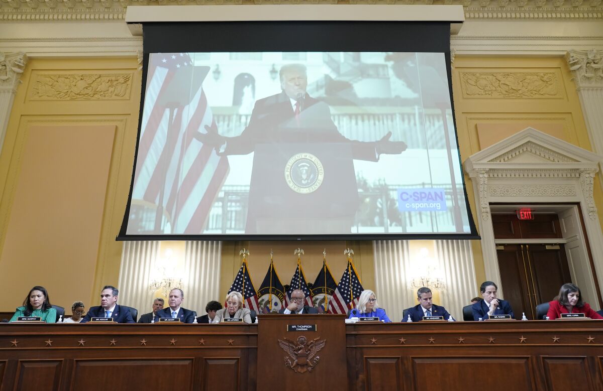 FILE - A video of former President Donald Trump speaking during a rally near the White House on Jan. 6, 2021, is shown as committee members from left to right, Rep. Stephanie Murphy, D-Fla., Rep. Pete Aguilar, D-Calif., Rep. Adam Schiff, D-Calif., Rep. Zoe Lofgren, D-Calif., Chairman Bennie Thompson, D-Miss., Vice Chair Liz Cheney, R-Wyo., Rep. Adam Kinzinger, R-Ill., Rep. Jamie Raskin, D-Md., and Rep. Elaine Luria, D-Va., look on, during a public hearing of the House select committee investigating the attack on Capitol Hill, Thursday, June 9, 2022, in Washington. (AP Photo/Andrew Harnik, File)
