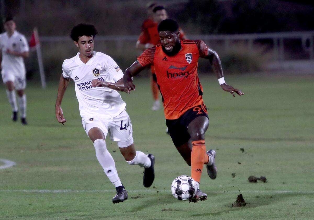 Orange County Soccer Club forward Sean Okoli, right, competes against L.A. Galaxy II defender Jalen Neal.