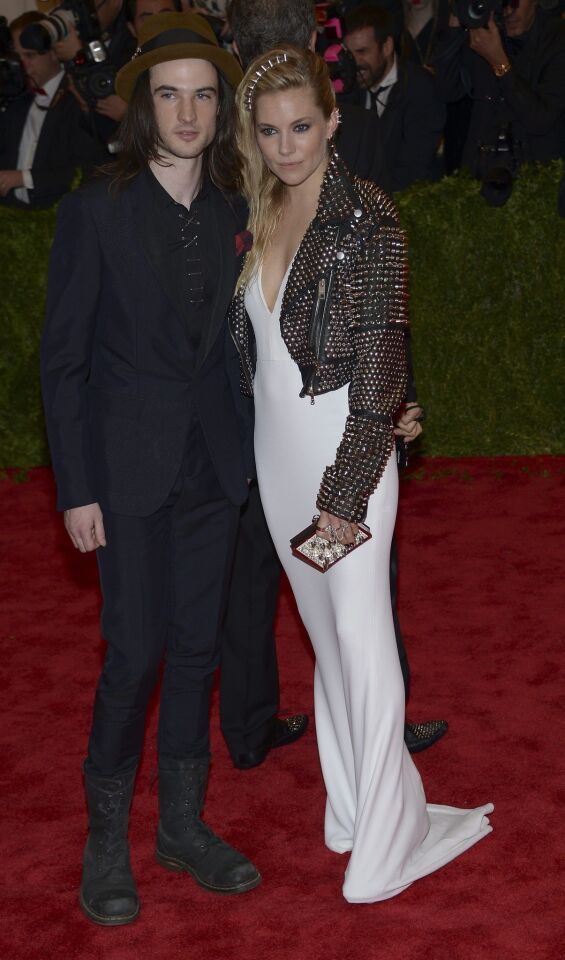 Sienna Miller in a Burberry crêpe and Tom Sturridge in a Burberry ink tuxedo.