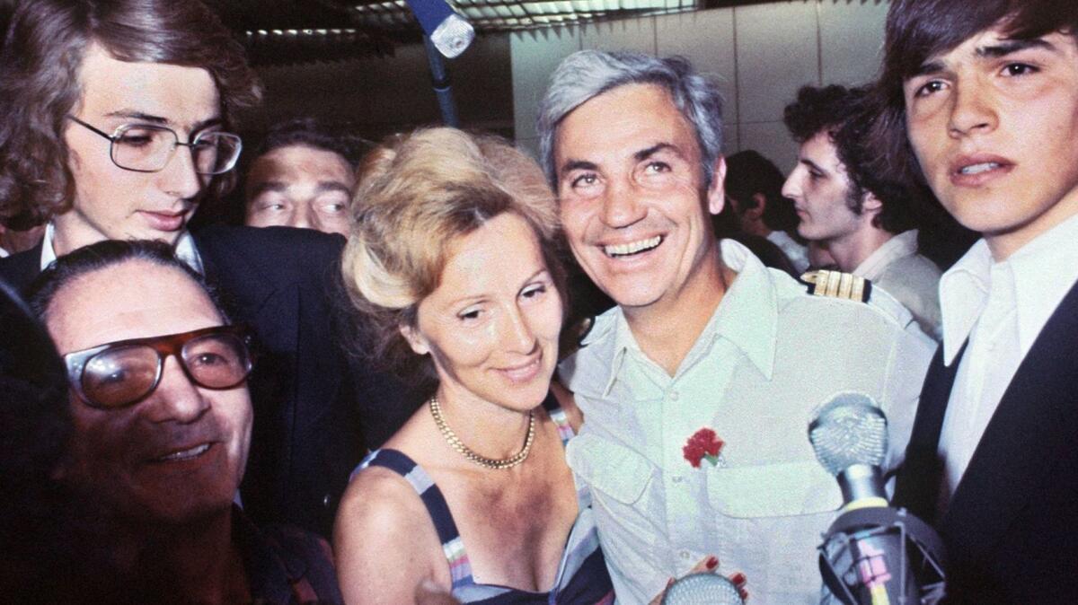 Air France pilot Michel Bacos is reunited with his wife at Orly Airport outside Paris after hijacking ordeal in 1976.