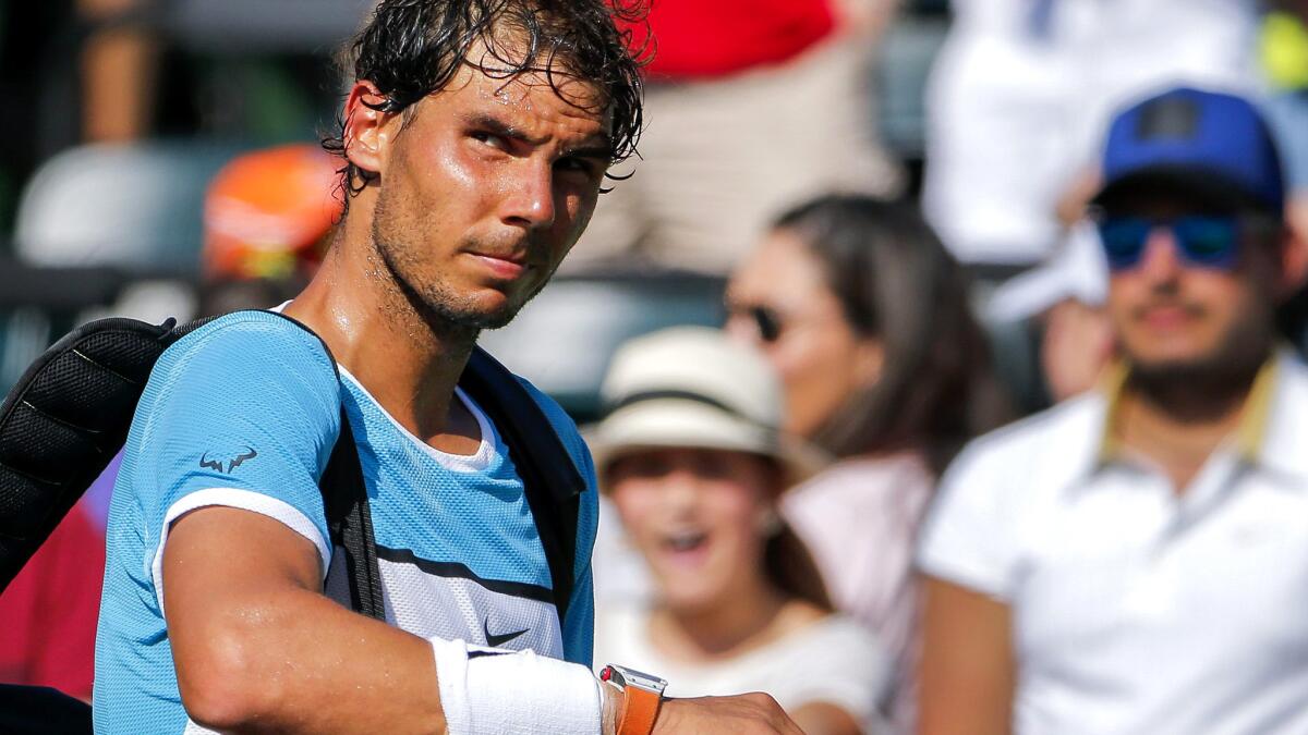 Rafael Nadal leaves the court after retiring from a match against Damir Dzumhur on Saturday.