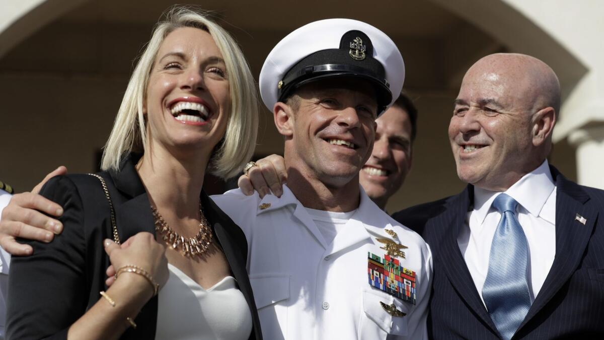 Navy Special Operations Chief Edward Gallagher, center, walks with his wife, Andrea Gallagher, and advisor Bernard Kerik as they leave a military court on Naval Base San Diego on Tuesday.
