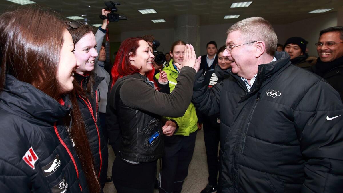 International Olympic Committee President Thomas Bach, right, visits the athletes village under constructions in Pyeongchang, South Korea, for the 2018 Winter Games on March 15.