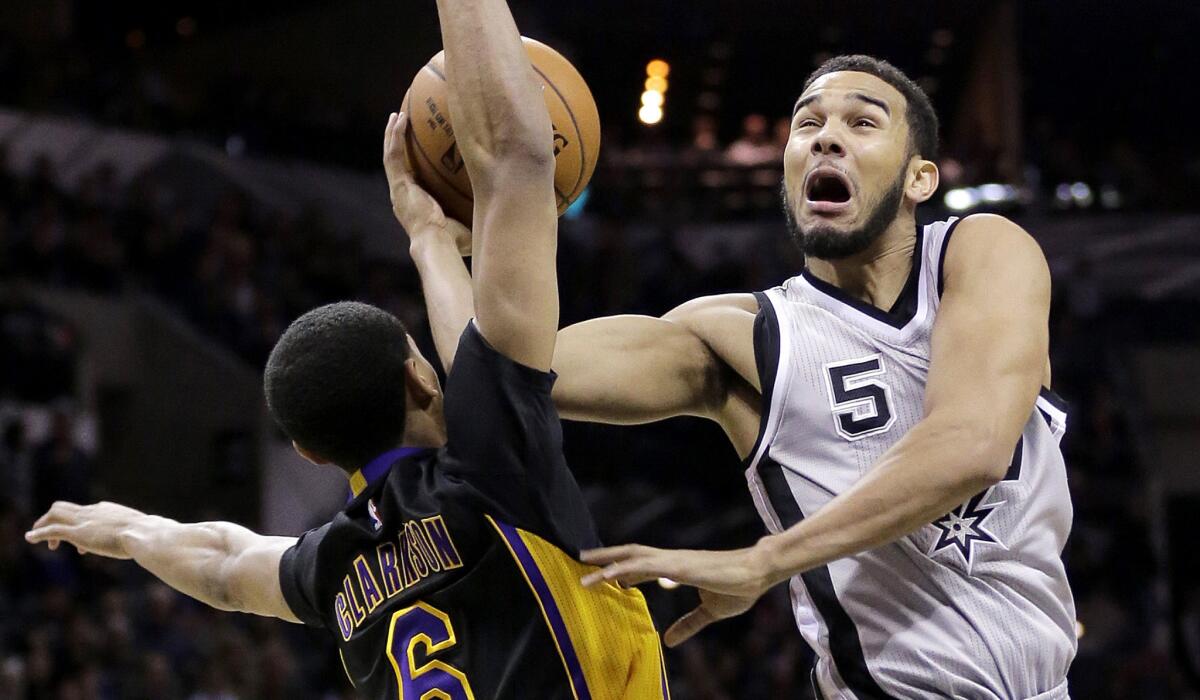 Lakers point guard Jordan Clarkson fouls Spurs guard Cory Joseph (5) as he tries to score in the second half.