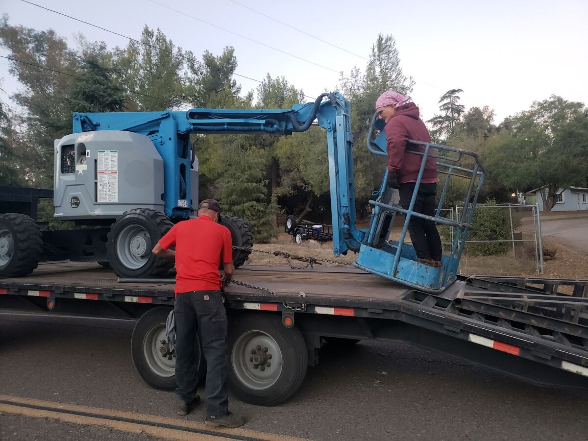 Mark Snavely and Chris Lent with the cherry picker used to rescue Owen the owl from the utility lines in Ramona.