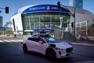 Los Angeles, CA - March 11: A Waymo robotaxi Jaguar I-PACEs driverless car makes a stop near Crypto.com Arena while driving around downtown in Los Angeles Monday, March 11, 2024. Waymo is about to announce the release of their robotaxi fleet across Los Angeles. The new service will allow users to go from downtown to Santa Monica, covering hundreds of miles. The service is expected to start this week but won't be available for all for a few more weeks. Waymo One fleet consists of fully electric Jaguar I-PACEs - the world's first premium electric autonomously driven vehicle. The Waymo Driver uses fully autonomous technology that is always in control of the vehicle from pickup to destination. (Allen J. Schaben / Los Angeles Times)