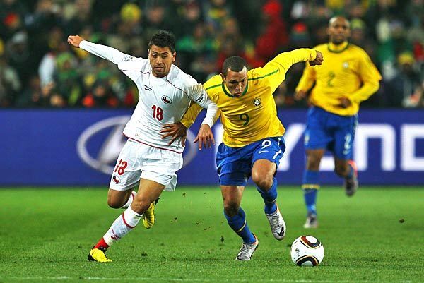 Gonzalo Jara of Chile, left, and Luis Fabiano of Brazil battle for the ball during a round-of-16 match at Ellis Park Stadium in Johannesburg, South Africa.