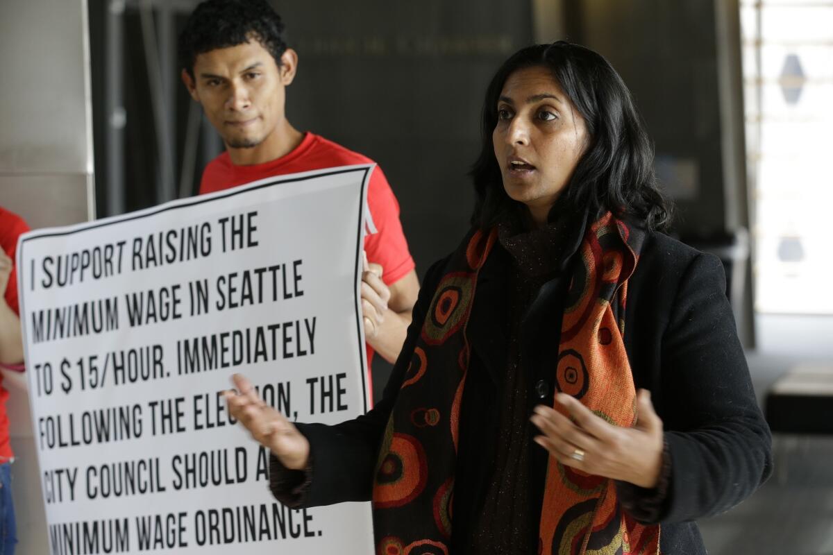 Kshama Sawant campaigns in Seattle, emphasizing her support for raising the minimum wage to $15 an hour for all workers in the city.