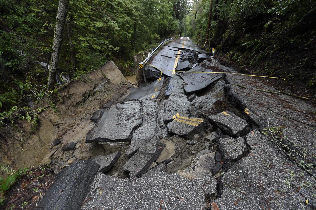 A two-lane road in a forested area crumbled into several pieces