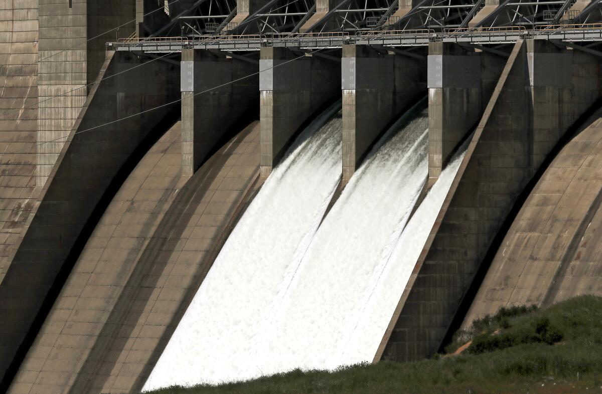 Water cascades down the face of Folsom Dam.