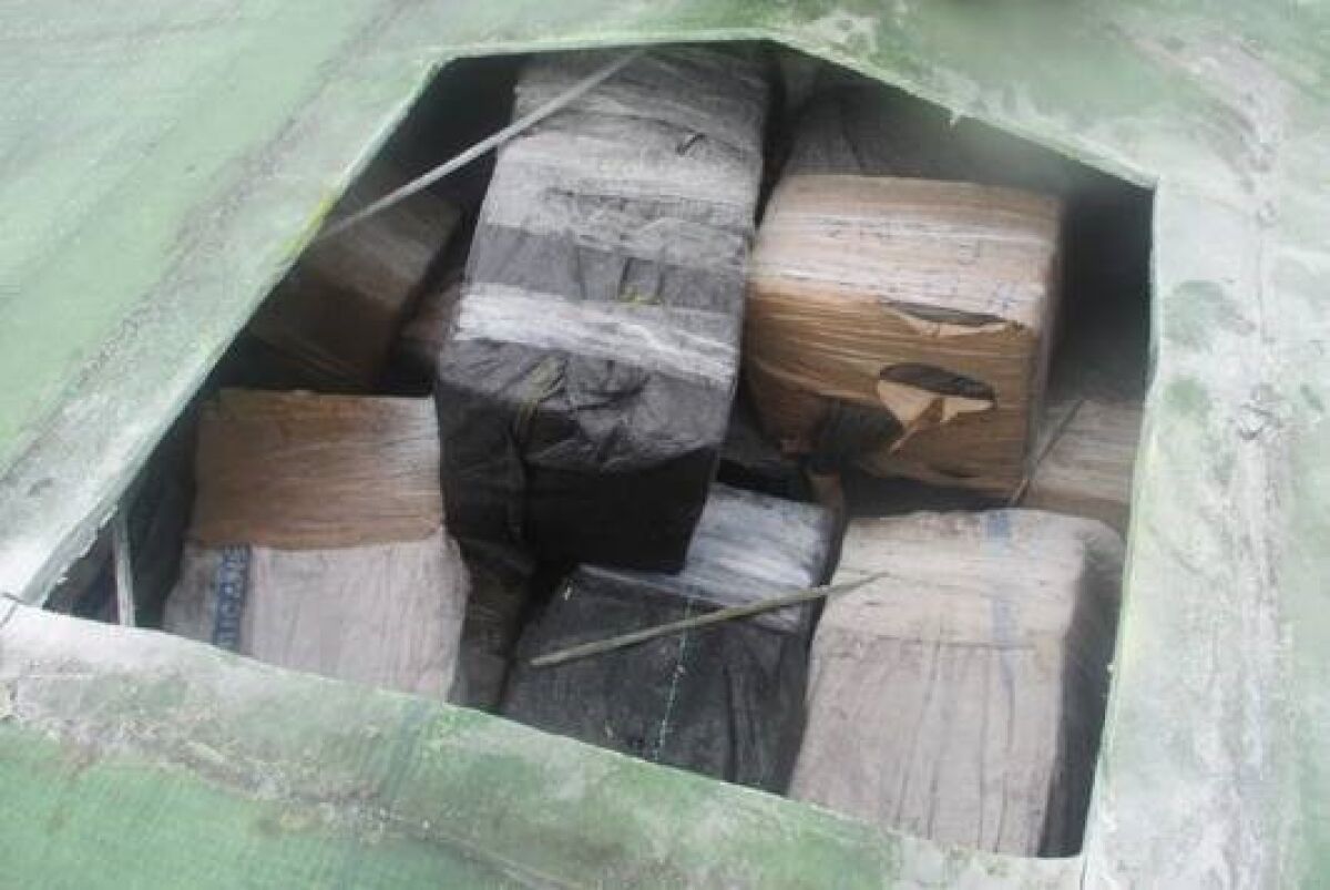 Bundles of cocaine are seen stacked inside a semi-submersible