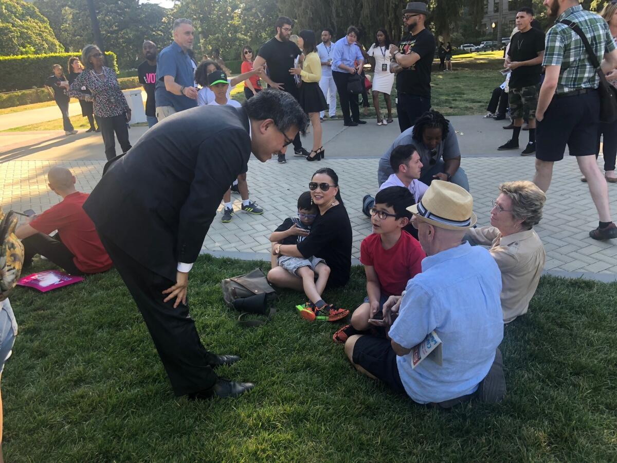 John Chiang greets the audience at a rally in Sacramento.