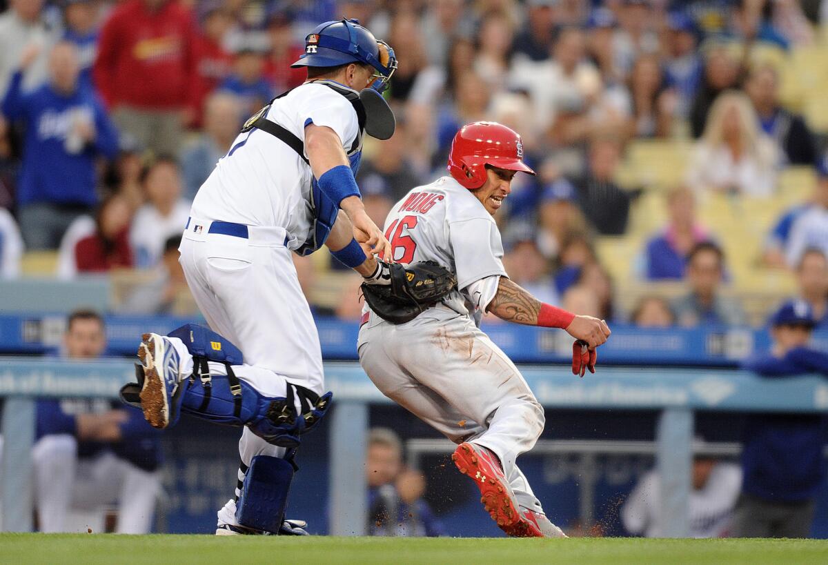 Dodgers catcher A.J. Ellis tags out Cardinals infielder Kolten Wong in a rundown during the second inning of a game on May 13 at Dodger Stadium.