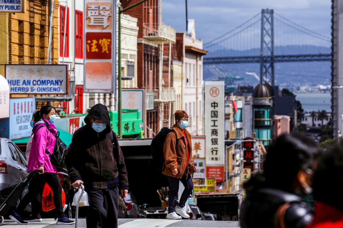 The corner of Jackson and Stockton streets in San Francisco's Chinatown, with the Bay Bridge in the background.