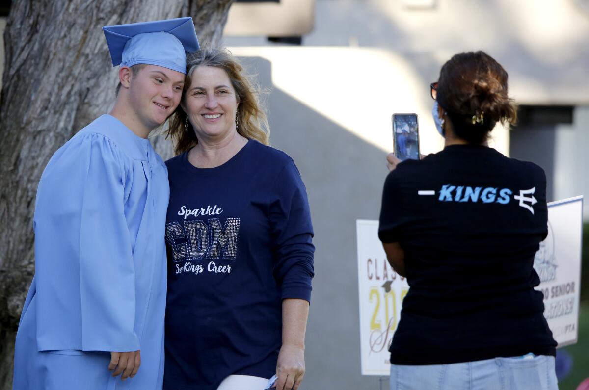 Zeke Eampietro, from Corona del Mar HS, poses with his mother Donna Eampietro for a photo taken by friend Julie Camire, right