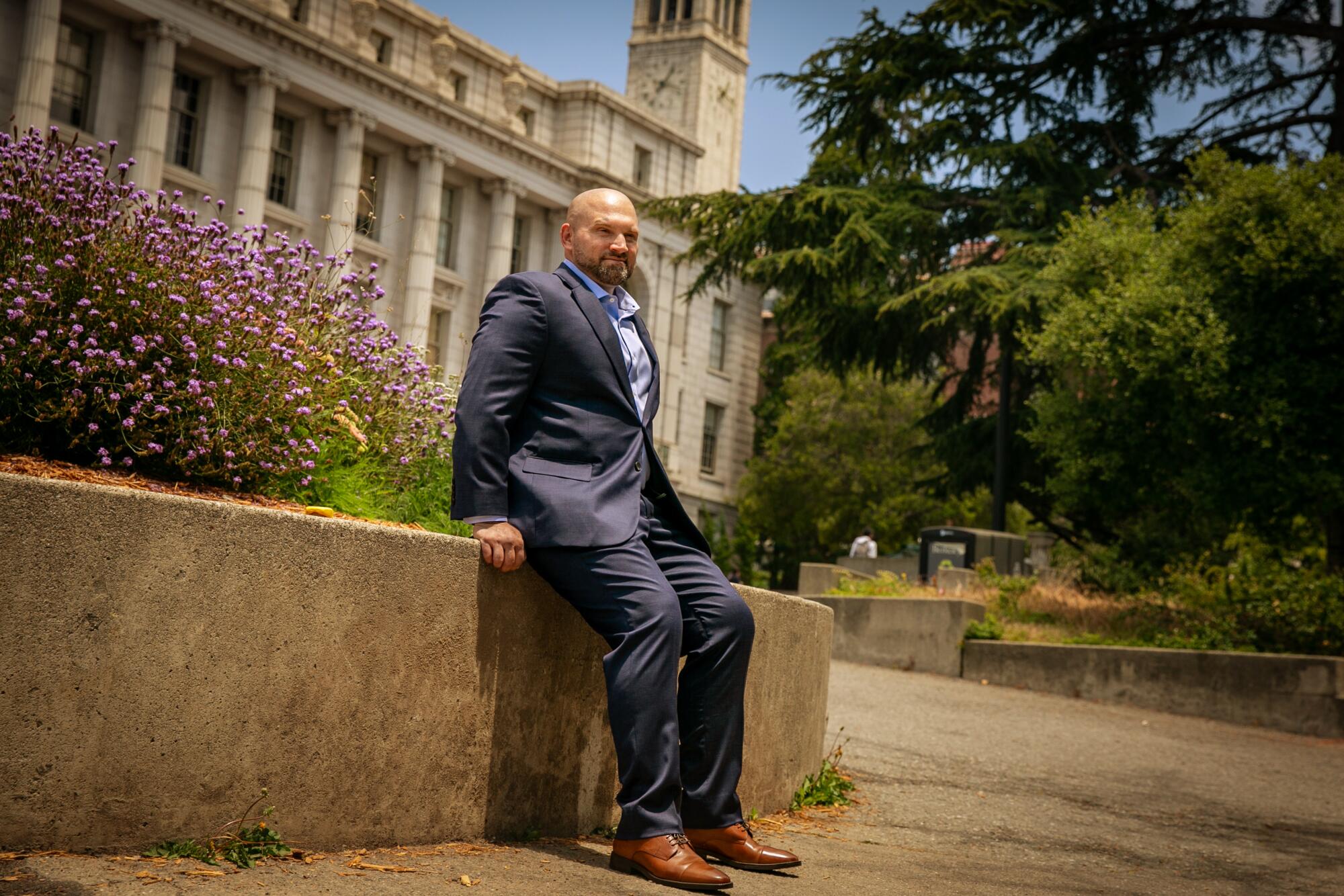 Kevin McCarthy poses in a suit on the UC Berkeley campus.