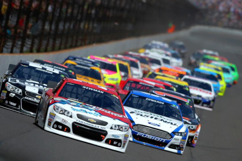 Ryan Newman, driver of the No. 39 Quicken Loans/The Smurfs Chevrolet, leads the field into turn one in the Brickyard 400 at Indianapolis Motor Speedway on Sunday.
