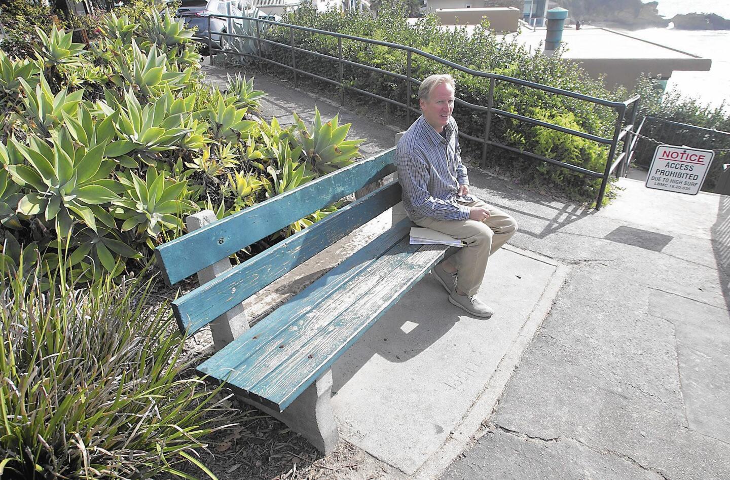 Resident Peter Mann sits on the bench at the Agate Street lookout where stairs leading to the beach have been damaged by large waves and high tides. The city plans to refurbish the stairs and landscape, which Mann says will compromise views.