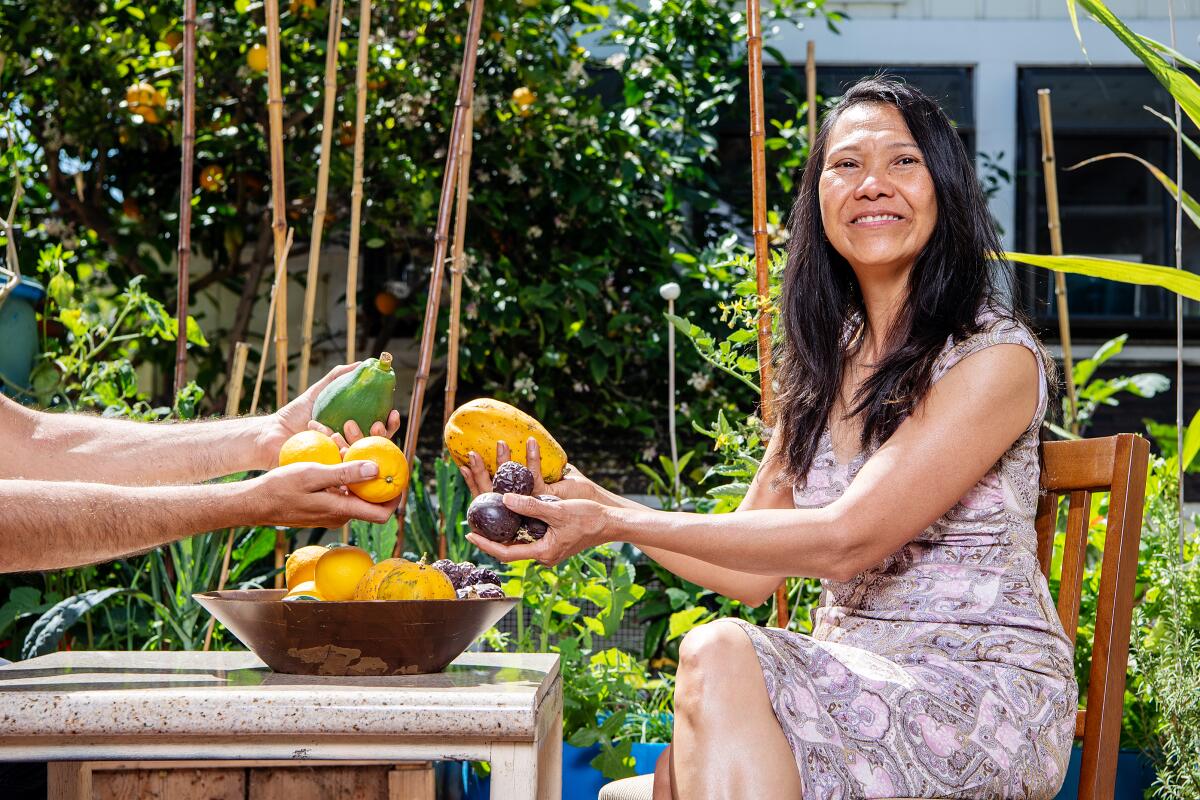 Thuy Tran exchanges fruit with someone