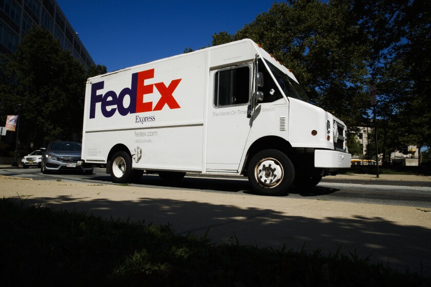 FILE - In this June 26, 2019, file photo a FedEx truck drives in Philadelphia. Amazon said it will allow its third-party sellers to start using FedEx's ground service again after banning them from using it for about a month during the busy holiday shopping season because FedEx purportedly wasn't delivering on time. (AP Photo/Matt Rourke, File)