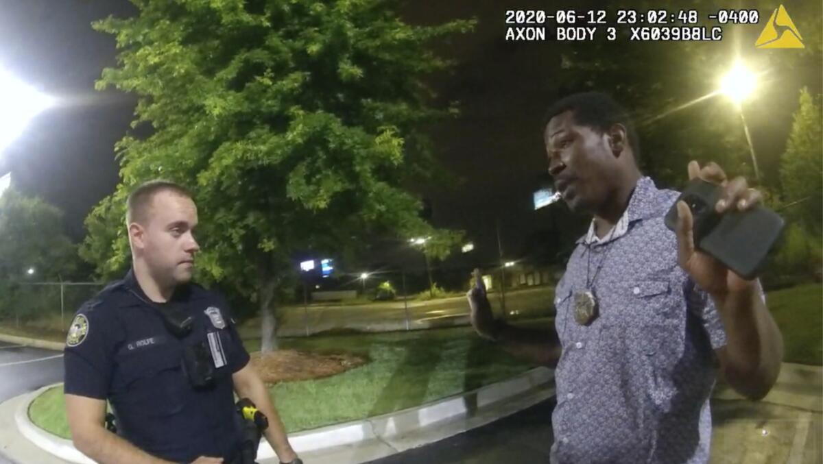 Rayshard Brooks, right, speaks with Atlanta Officer Garrett Rolfe 