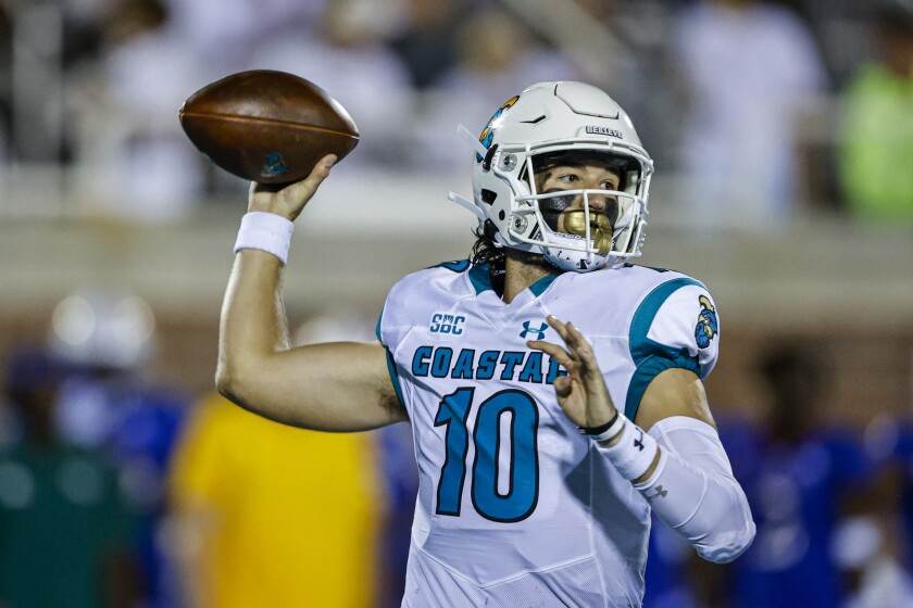 FILE - Coastal Carolina quarterback Grayson McCall looks to pass against Kansas during the first half of an NCAA college football game in Conway, S.C., Friday, Sept. 10, 2021. McCall had surgery last month, his right arm is in a sling and he can't turn his shoulder loose to throw until right before the start of preseason camp this summer. Still, he'll be a willing, active spectator as the Chanticleers go through spring workouts. (AP Photo/Nell Redmond, File)