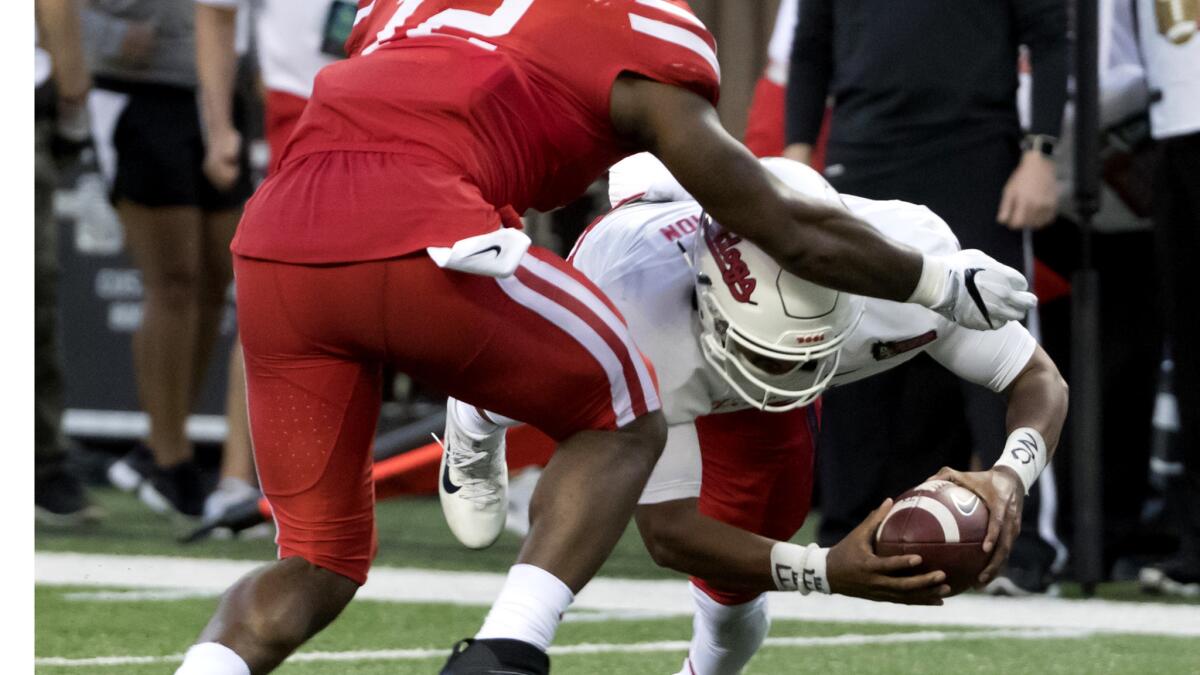 Fresno State quarterback Marcus McMaryion dives into the end zone for a touchdown underneath Houston linebacker D'Juan Hines during the second half Sunday night.
