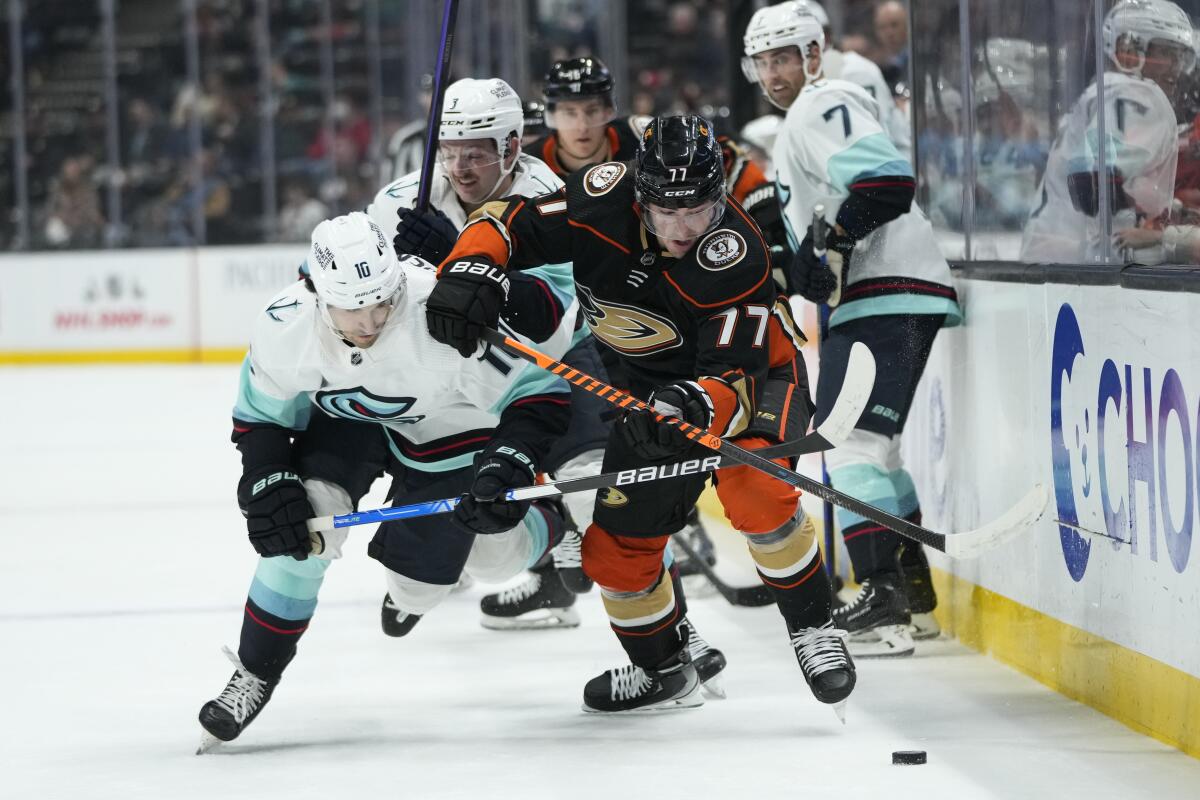 Anaheim Ducks' Frank Vatrano (77) and Seattle Kraken's Matty Beniers (10) chase the puck