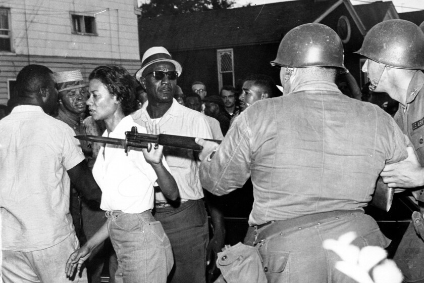 FILE - In this July 21, 1963, file photo, Gloria Richardson, head of the Cambridge Nonviolent Action Committee, pushes a National Guardsman's bayonet aside as she moves among a crowd of African Americans to convince them to disperse in Cambridge, Md. Richardson, an influential yet largely unsung civil rights pioneer whose determination not to back down while protesting racial inequality was captured in a photograph as she pushed away the bayonet of a National Guardsman, died Thursday, July 15, 2021, in New York, according to Joe Orange, her son in law. She was 99. (AP Photo/File)