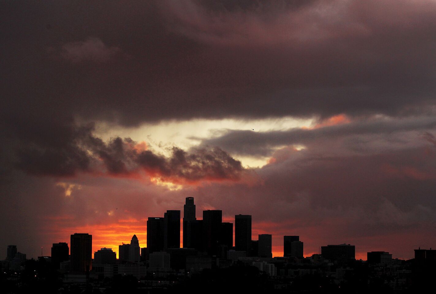 Storm clouds drift over downtown Los Angeles as the sun sets. The brunt of a Pacific storm struck Southern California, dropping about 1.5 inches of rainfall on the Civic Center.