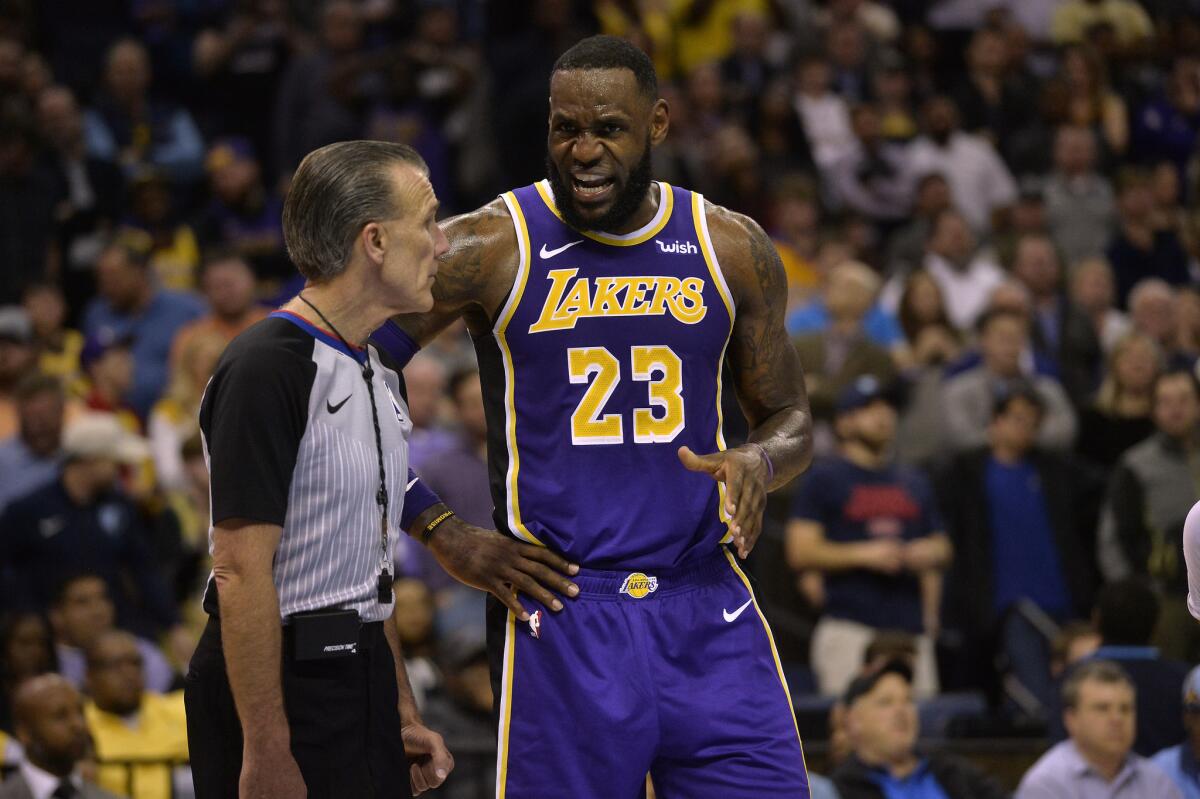 Los Angeles Lakers forward LeBron James (23) talks with referee Ken Mauer in the second half of an NBA basketball game against the Memphis Grizzlies Monday, Feb. 25, 2019, in Memphis, Tenn.