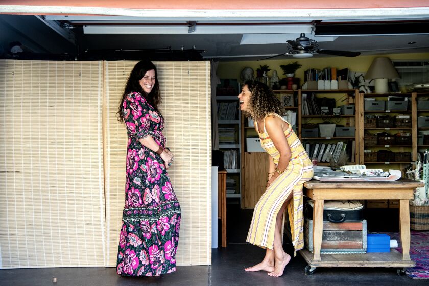 CULVER CITY, CA - SEPTEMBER 14: German photographer Sally Montana, left, and interior designer Faith Blakeney are all laughs inside the garage, which is now both women's workspace, on Wednesday, Sept. 14, 2022 in Culver City, CA. (Mariah Tauger / Los Angeles Times)